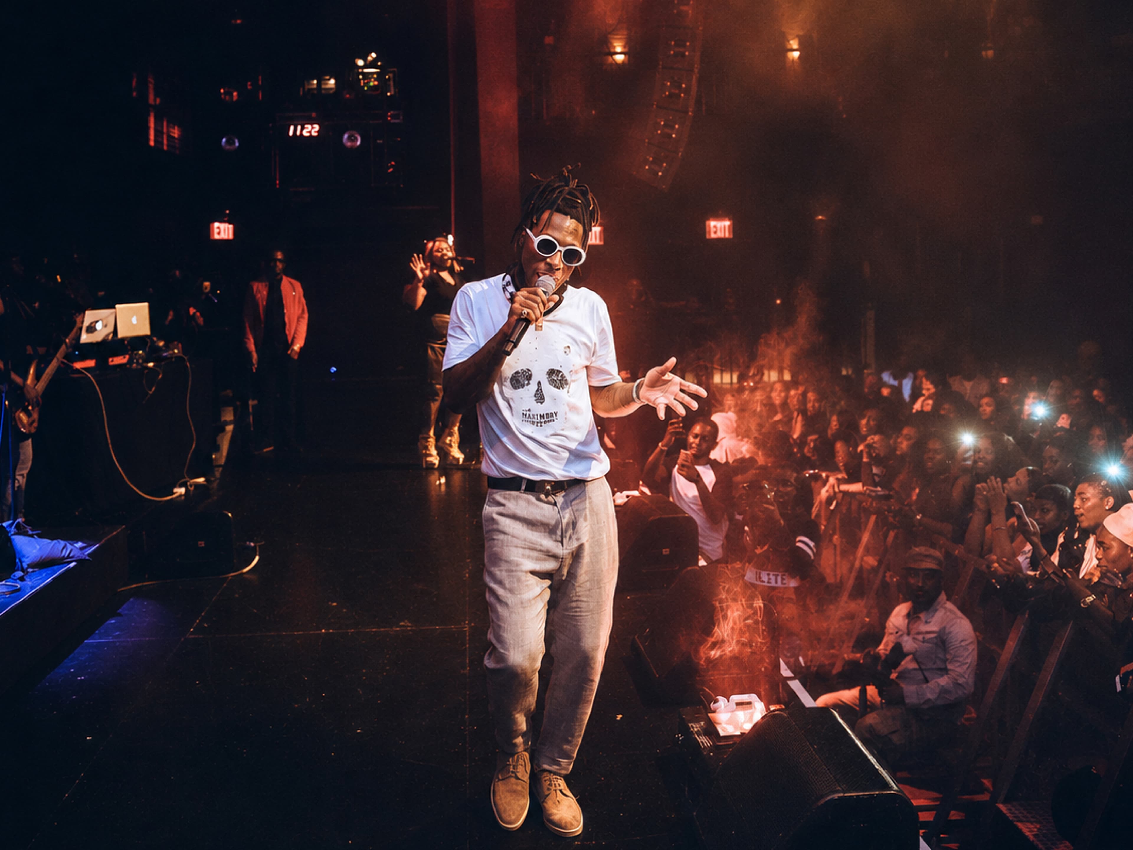 Burna Boy performing on stage to a packed crowd during his debut North American tour